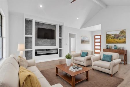 Living room featuring beam ceiling, hardwood / wood-style flooring, a healthy amount of sunlight, and high vaulted ceiling