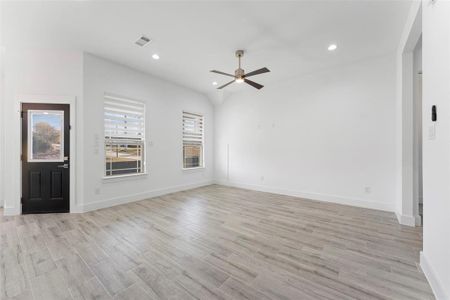 Unfurnished living room with ceiling fan and light hardwood / wood-style floors