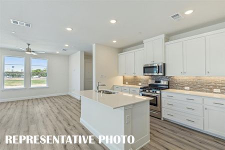 The spacious island is the center of attention in this fantastic kitchen!  REPRESENTATIVE PHOTO