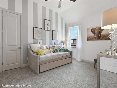 Bedroom featuring ceiling fan, carpet, and vaulted ceiling