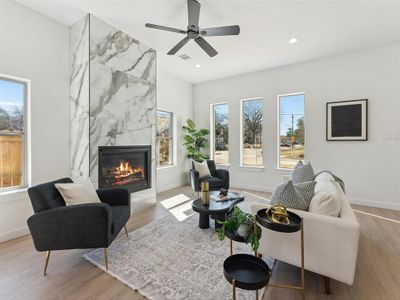 Living area with recessed lighting, visible vents, a premium fireplace, light wood-type flooring, and baseboards