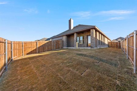 Rear view of property with a lawn