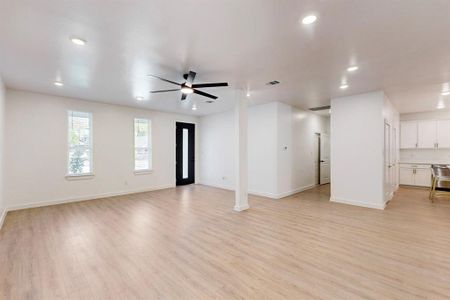 Unfurnished living room with ceiling fan and light hardwood / wood-style floors