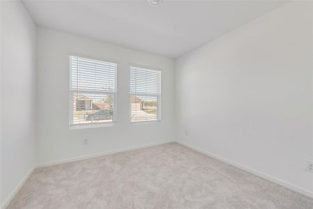 Unfurnished room featuring light colored carpet