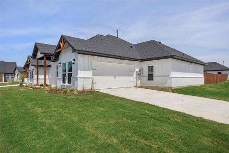 View of front of property with a garage and a front yard