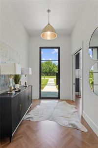 Entrance foyer featuring white oak hardwoods in a herringbone pattern.