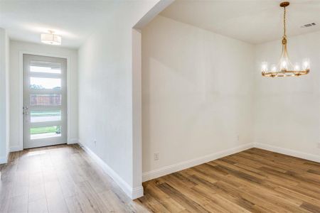 Foyer featuring an inviting chandelier and hardwood / wood-style floors