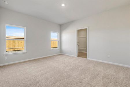 Large, primary bedroom with beautiful windows.