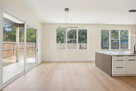 Unfurnished dining area with light wood-type flooring and plenty of natural light