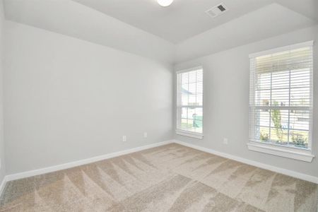 At the forefront of the home, a guest suite with its own bathroom awaits. Sample photo of completed home with similar floor plan. Actual colors and selections may vary.