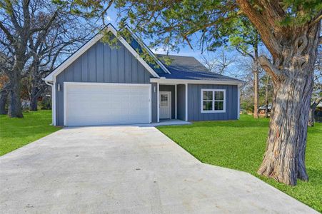 View of front of house with a front yard and a garage