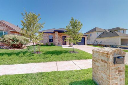 View of front of property with a front lawn and a garage