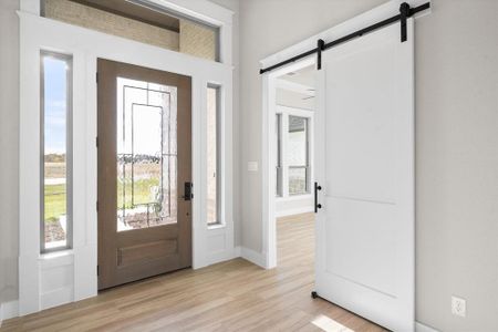 Entrance foyer with light wood-type flooring