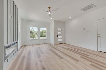 Empty room with light wood-type flooring and ceiling fan