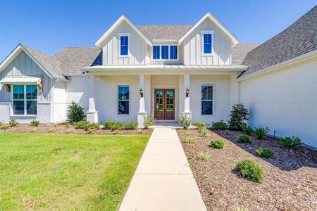 Modern inspired farmhouse with french doors and a front lawn