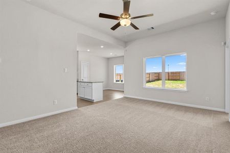 The cozy living room overlooks the covered back patio and backyard.