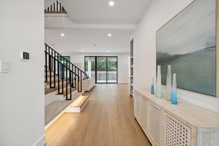 As you step inside, you will be captivated by the front foyer's high ceilings and stunning engineered solid wood flooring!