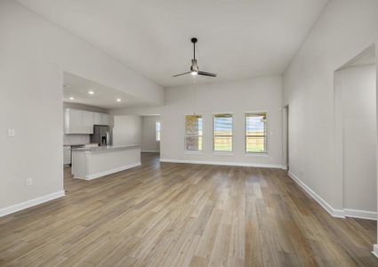 Spacious family room with plank flooring and a ceiling fan