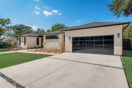 View of front of house with a front yard and a garage