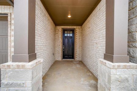 View of exterior entry with brick siding