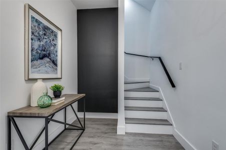 Stairs featuring hardwood / wood-style flooring