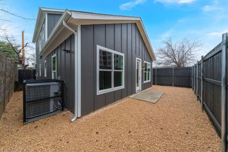 Back of property featuring central air condition unit, a fenced backyard, and board and batten siding