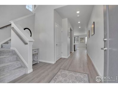 Beyond the front porch is a welcoming, two-story foyer