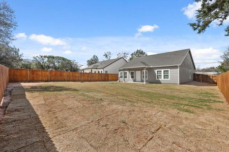 Back of property featuring a lawn and a fenced backyard