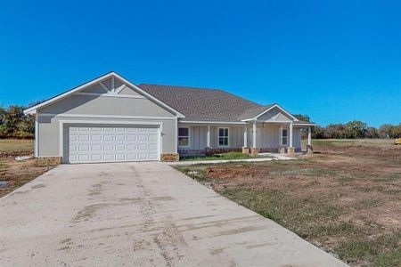 Single story home with covered porch and a garage