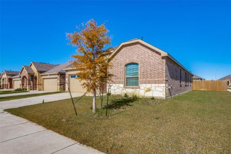 View of front of home with a garage and a front yard