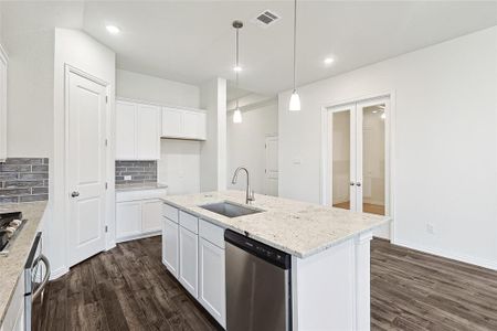 Kitchen with dishwasher, dark wood-type flooring, sink, and white cabinets