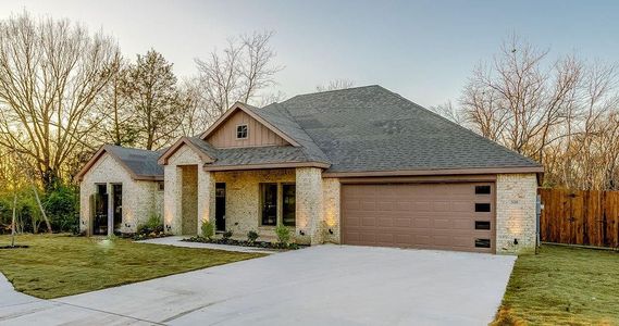 View of front of home with a front lawn and a garage