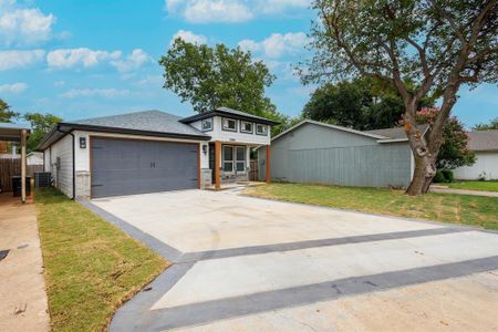 View of front of house featuring a front lawn, a garage, and central AC unit