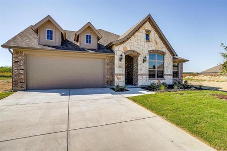 View of front of home featuring a garage and a front lawn