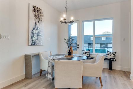 Dining space with an inviting chandelier and light wood-type flooring