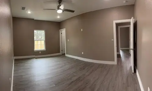 Unfurnished room featuring visible vents, ceiling fan, baseboards, recessed lighting, and wood finished floors