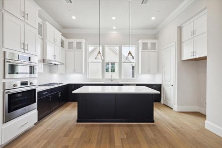 Spacious kitchen with LARGE island.   This photo is from a previous build with similar finishes.