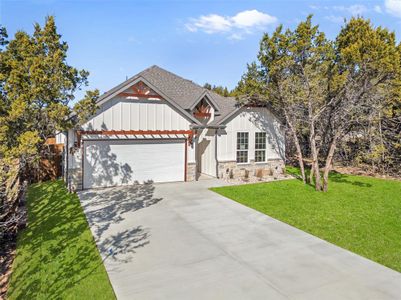 View of front of house with a front yard and a garage