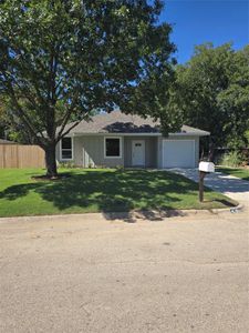 Ranch-style home with a garage and a front yard