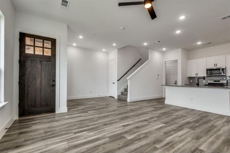 Foyer entrance featuring light hardwood / wood-style flooring, ceiling fan, and sink