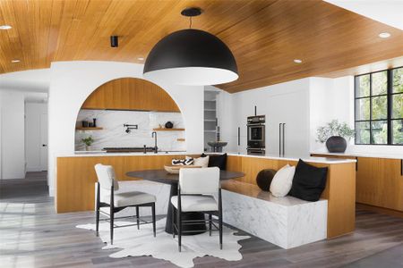 Seating area built-in off of the large and functional kitchen island.