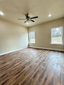 Spare room with ceiling fan and dark wood-type flooring