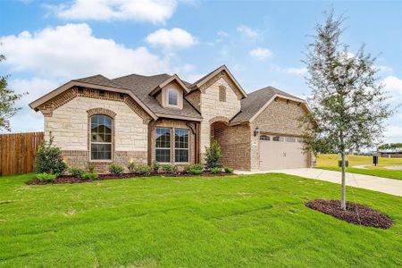 French country home with a front yard and a garage