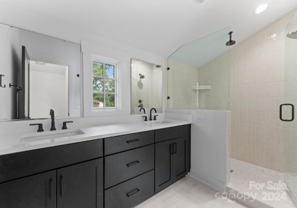 Luxurious primary bathroom with designer selections and dual sinks.