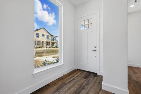 Entryway with baseboards and dark wood-type flooring