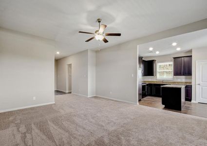 Open-concept layout with the living room opening up to the kitchen and dining room.