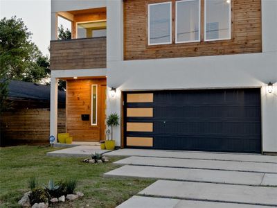 Modern home with a garage and a front lawn