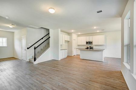 The Oriole II- Family Room into the Kitchen. Home under construction, photo used for illustrative purposes only, colors and options will vary.