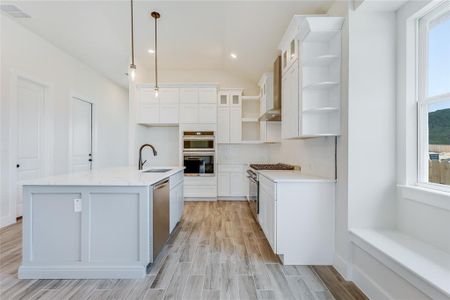 Well appointed kitchen with open shelving and farmhouse sink!