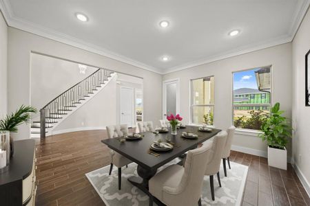 Virtually Staged: Spacious dining room with new tile floors, new recessed lighting, crown molding, and direct views to the front of the house.